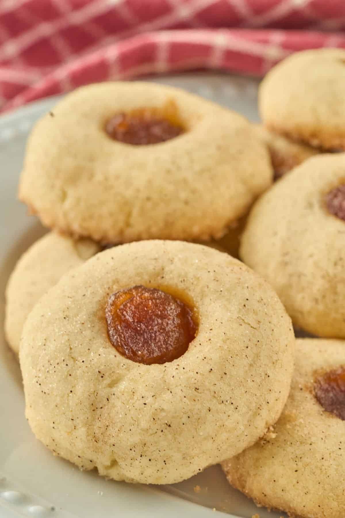 plate of thumbprint cookies with apple butter in center.