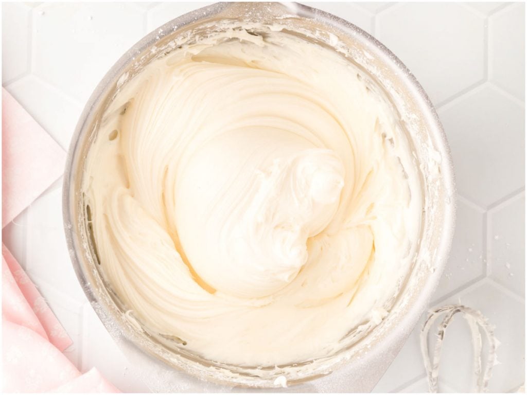 Smooth cream cheese frosting in a mixing bowl