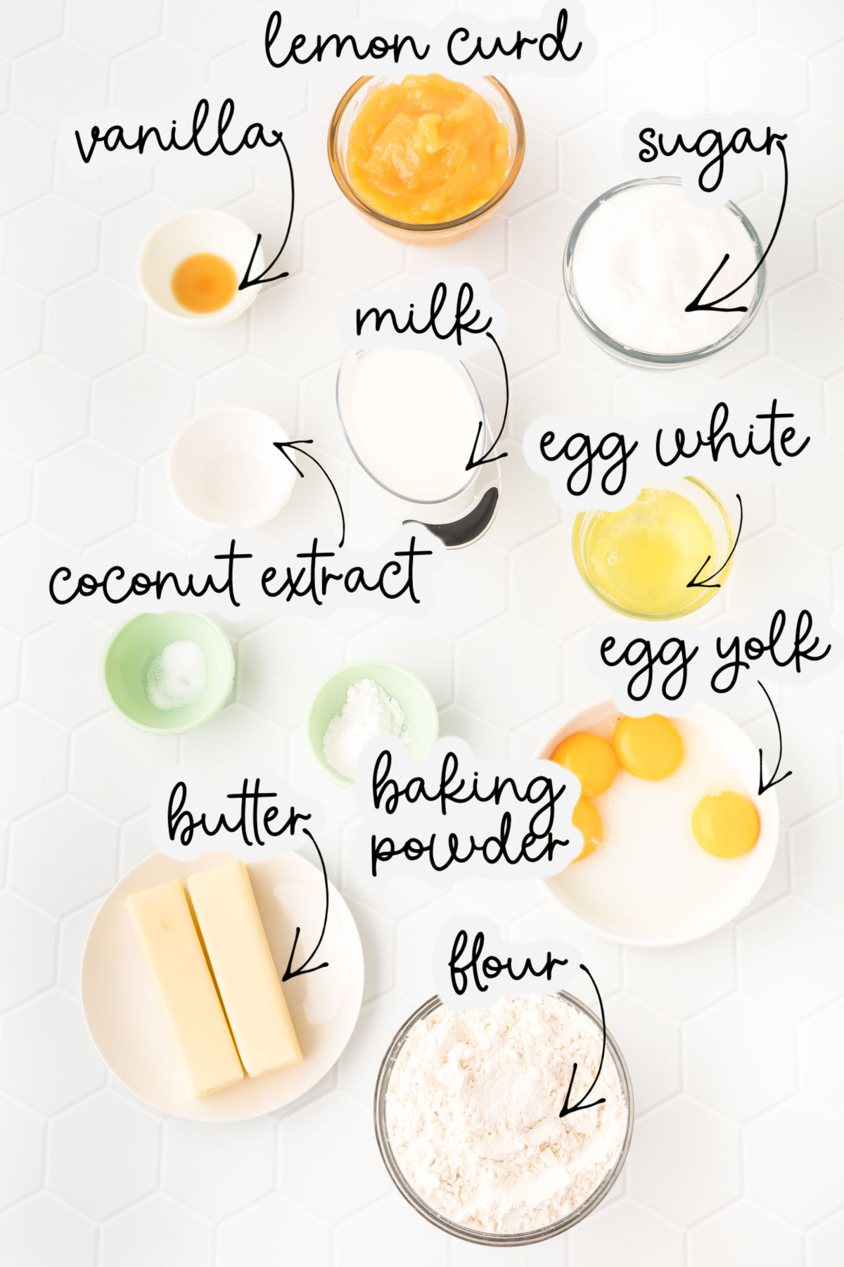 Ingredients for coconut lemon cupcakes including lemon curd, vanilla, sugar, milk, and egg whites