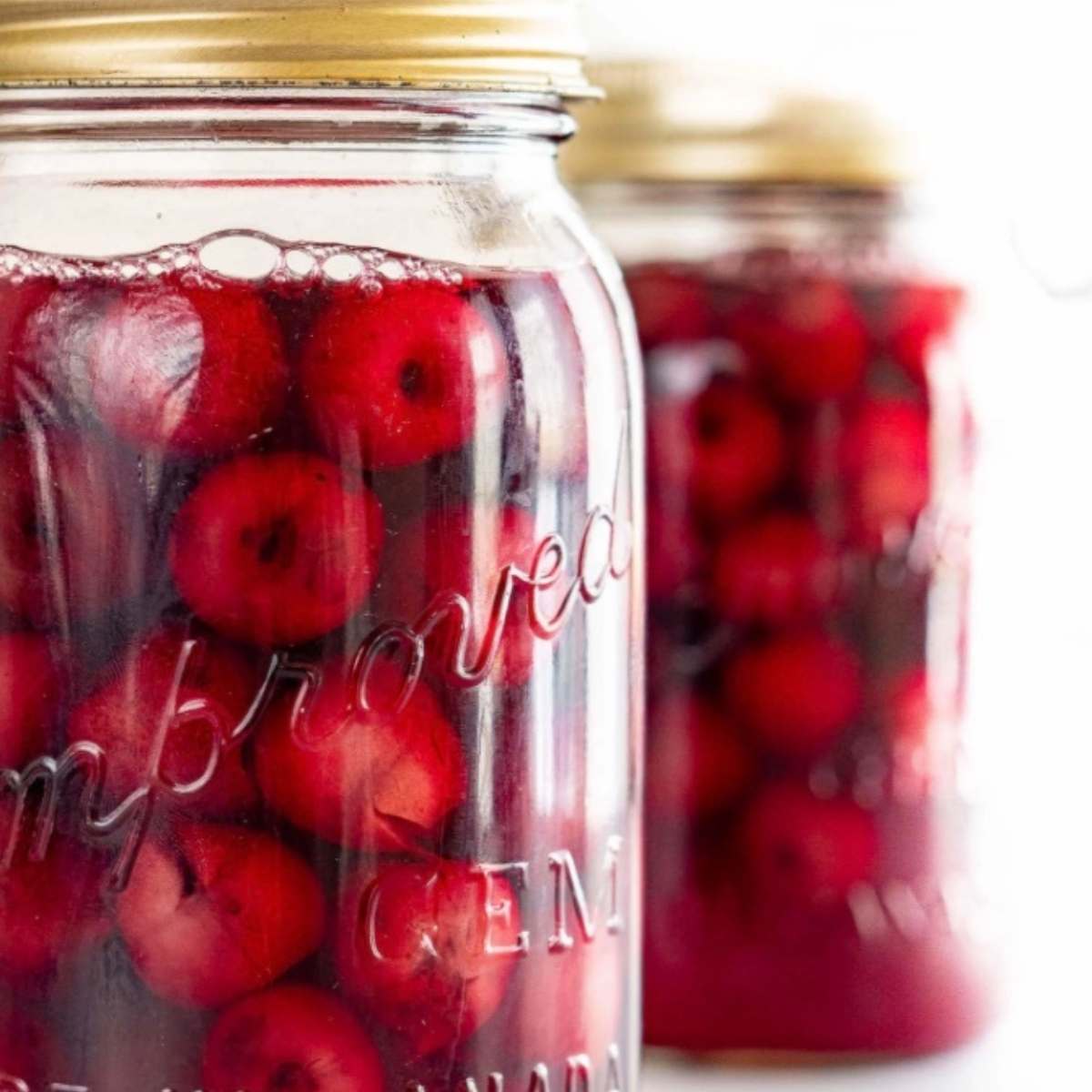 quart sized mason jars filled with red cherries