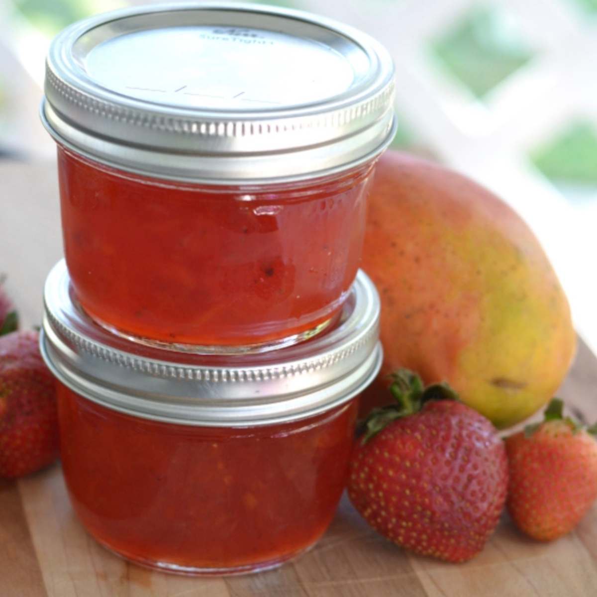 2 small mason jars of jam stacked on top of each other