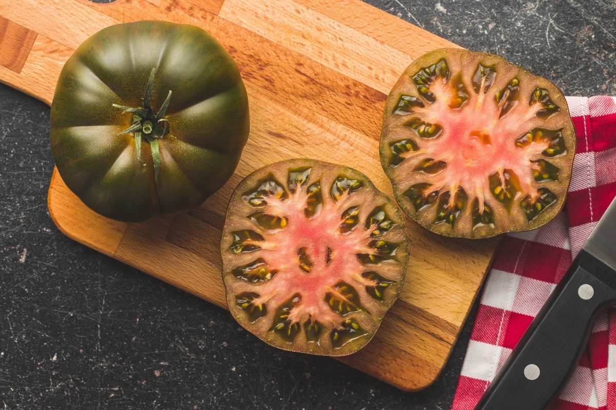 checkered napkin with brandywine tomato on cuttting board