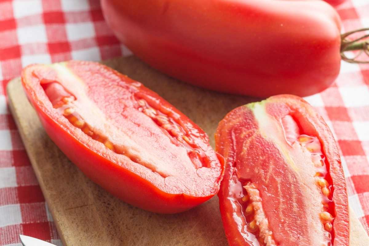 roma tomato cut in half to show seeds and meat