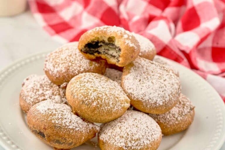 white plate of fried oreos with bite missing