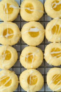 one dozen thumbprint cookies with lemon curd in center
