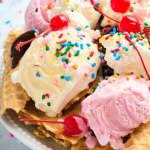 close up view of cones, scoops of ice cream, and whipped cream