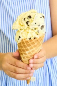 girl in striped dress holding ice cream cone