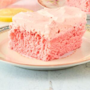 square slice of pink cake with pink frosting