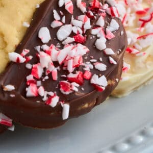 close up view of cookie topped with chocolate and crushed candy cane.