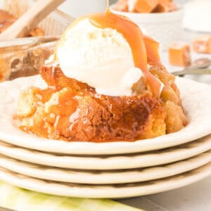 plate of apple cobbler with ice cream and caramel sauce