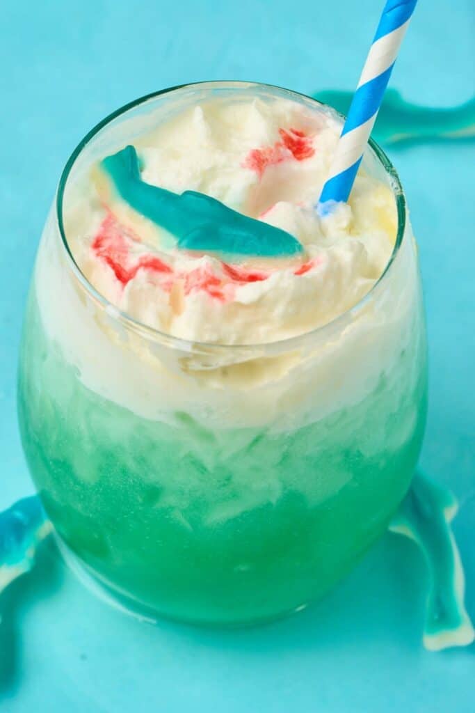blue drink with whipped cream and shark gummy