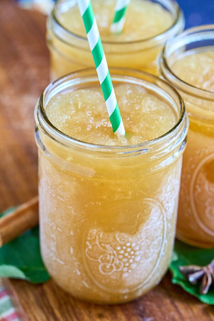 slushie apple cider in glass on board.