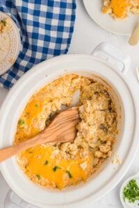 wooden scoop in crockpot scooping out finished dish