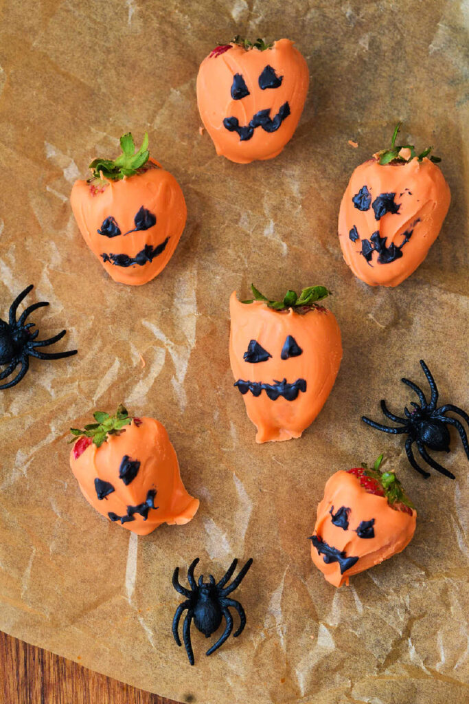 6 pumpkin decorated strawberries.