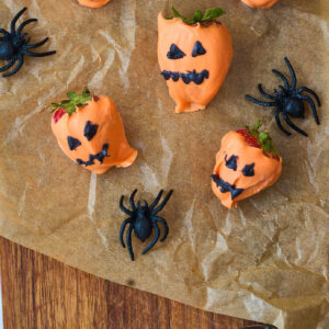 close up of strawberries with fake spiders.