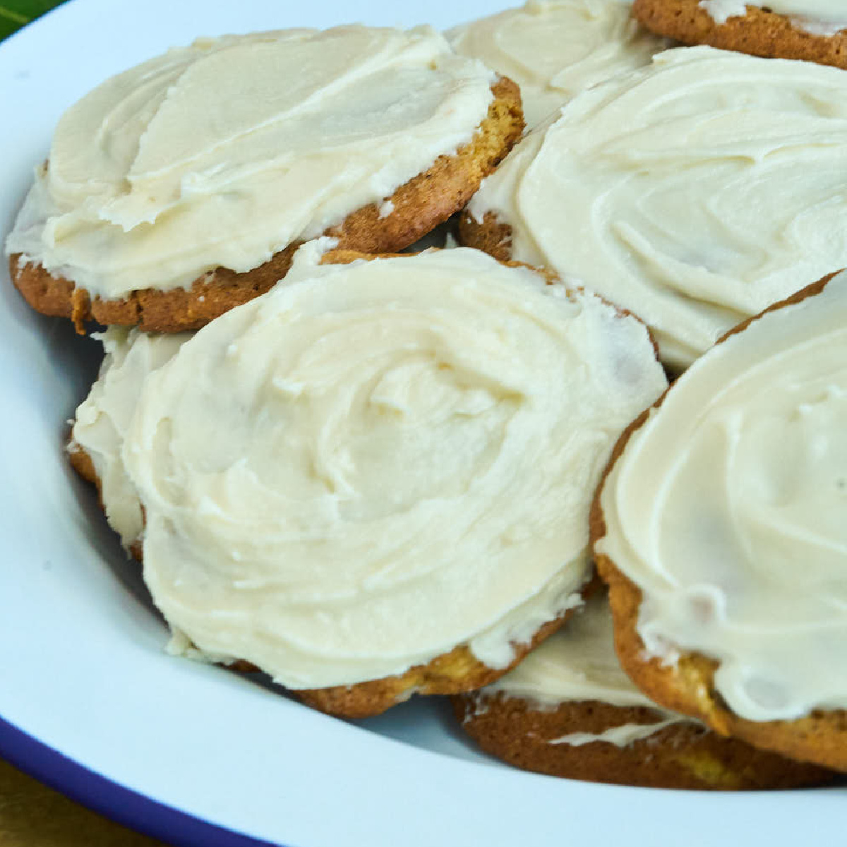 whitie plate with dark cookies topped with off white icing.