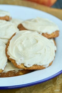 plate of brown cookies iced with buttercream.