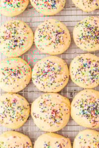 finished cookies with rainbow sprinkles on wire rack.