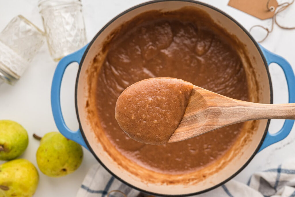 wooden spoon with scoop of pear butter.