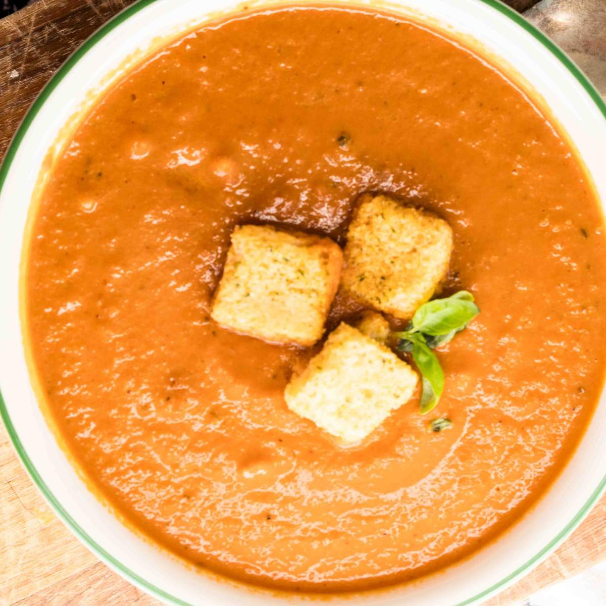 bowl of roasted tomato soup with croutons