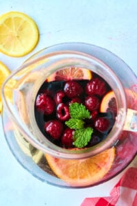 overhead view of pitcher with mint and berries.