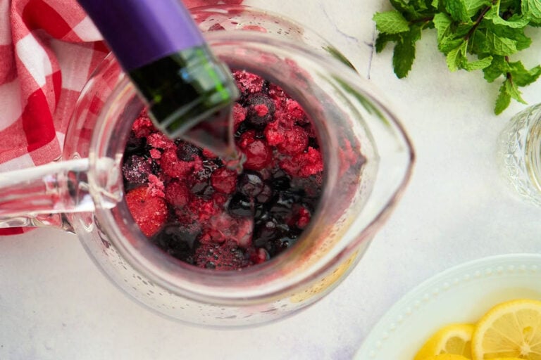 pitcher with wine being poured in.