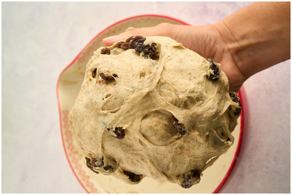 hand shaping dough into ball.