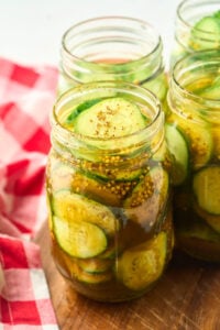 mason jars of finished sliced round pickles.