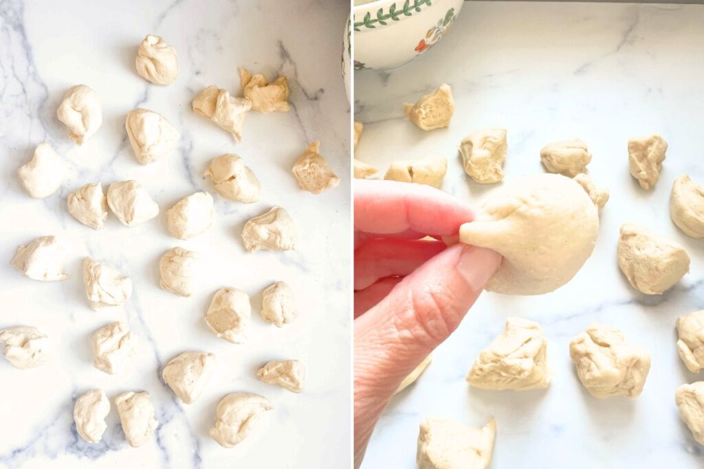 hand shaping dough into rolls.