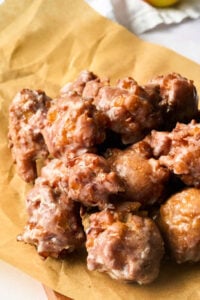 apple fritters on brown parchment.