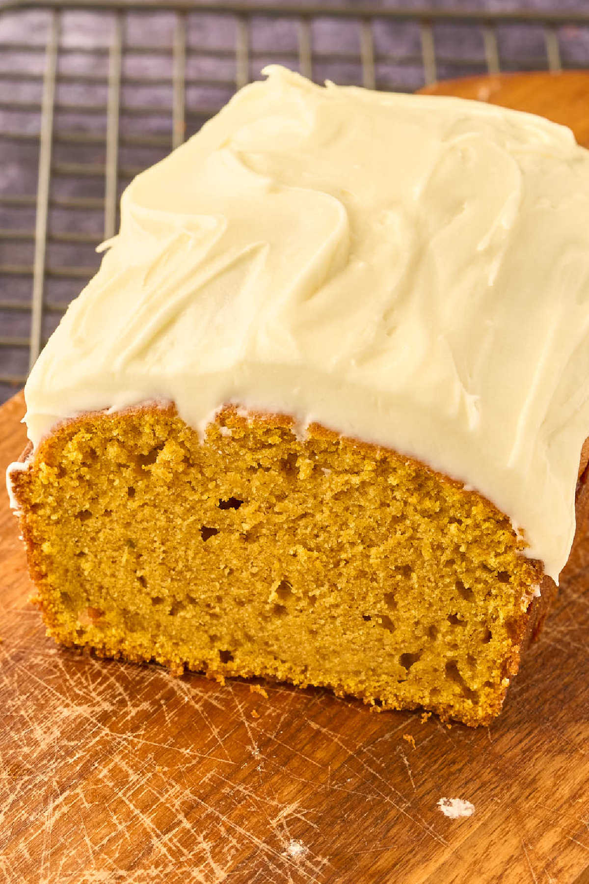 loaf of pumpkin bread on cutting board.