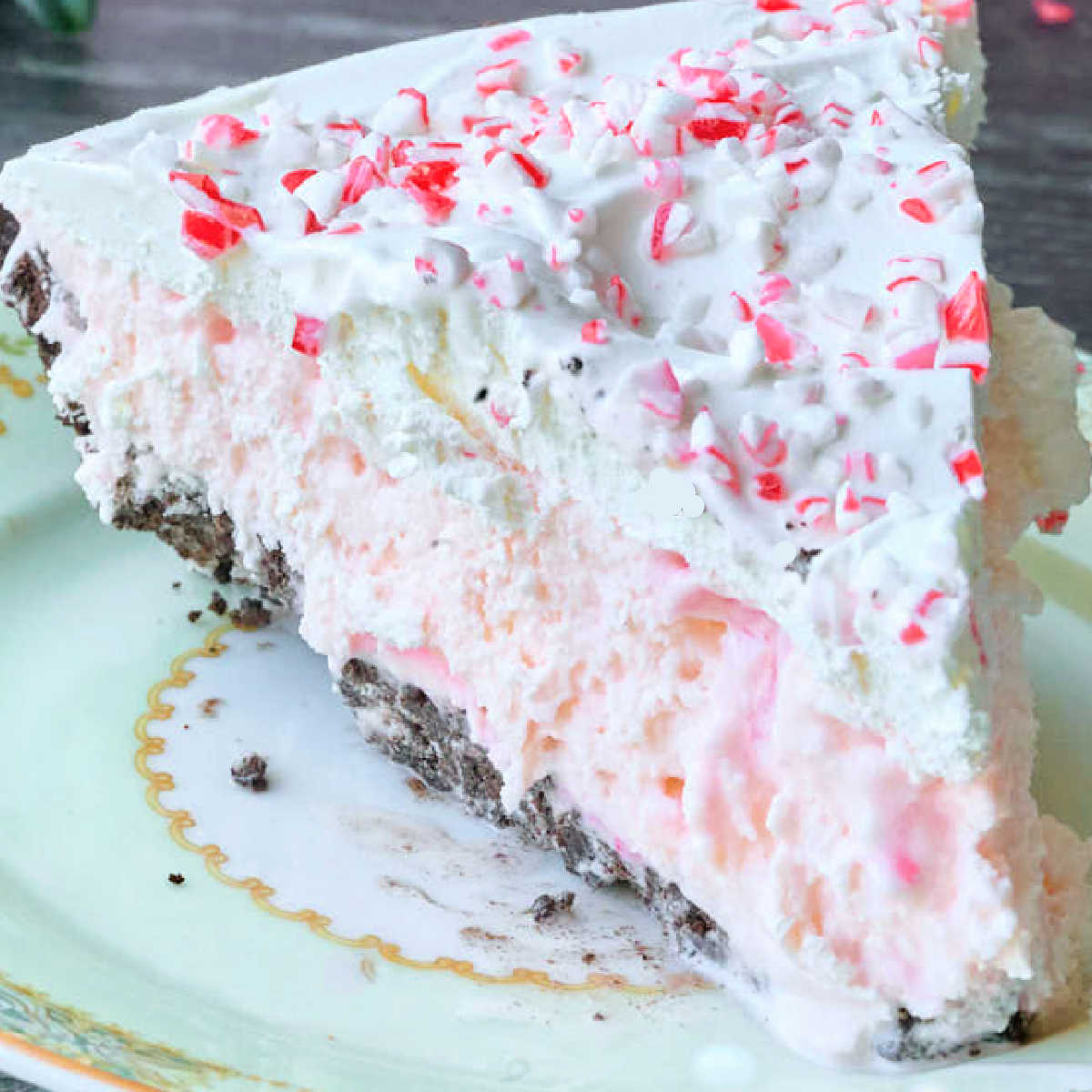 slice of ice cream pie with oreo crust and candy canes.