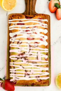 overhead view of strawberry wuuick bread with white glaze.