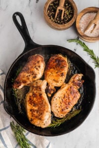 cast iron skillet with 4 pork chops.