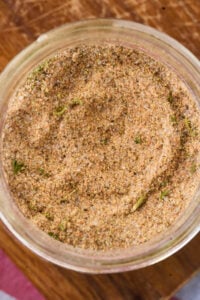 close up view of mixed seasoning in glass jar.