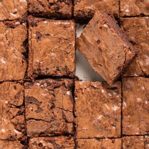 Top-down view of sliced brownies in a pan.