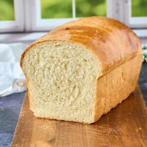 wooden cutting board with loaf of bread.