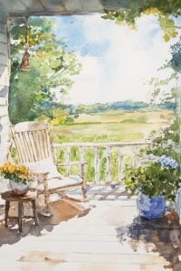 porch with rocking chair and field in background.