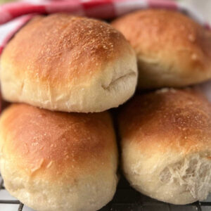 four hoagie rolls on rack.