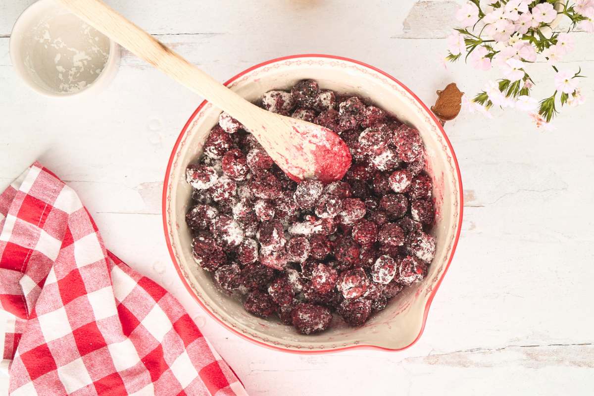 berries mixed with sugar and cornstarch in bowl.
