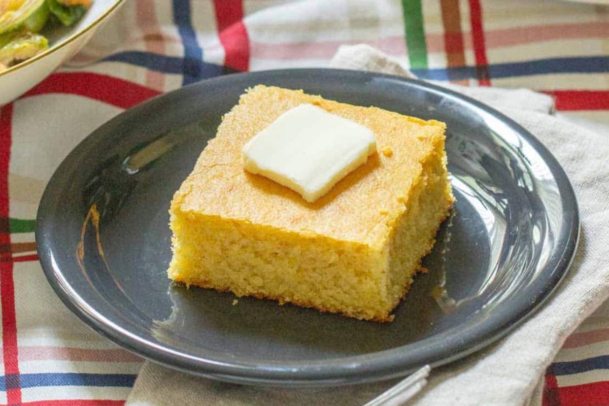 square piece of cornbread topped with butter