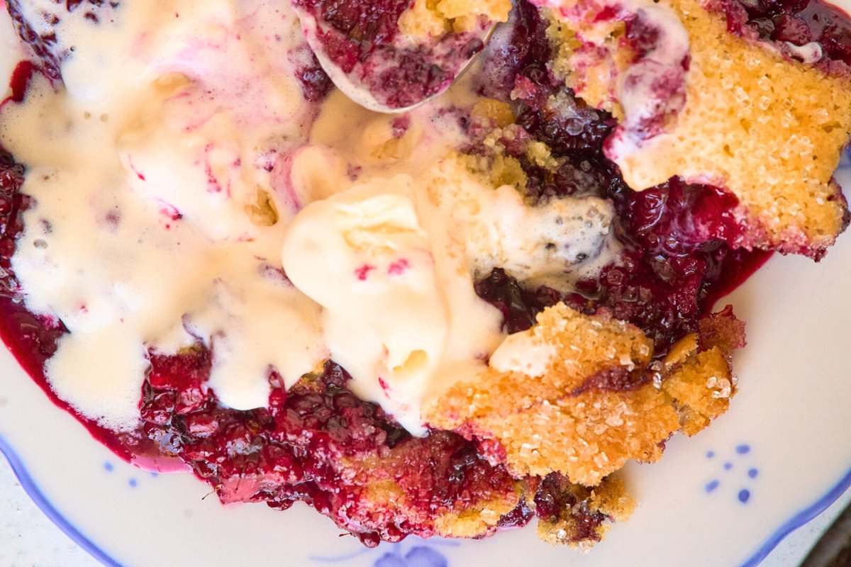 finished cobbler topped with ice cream.