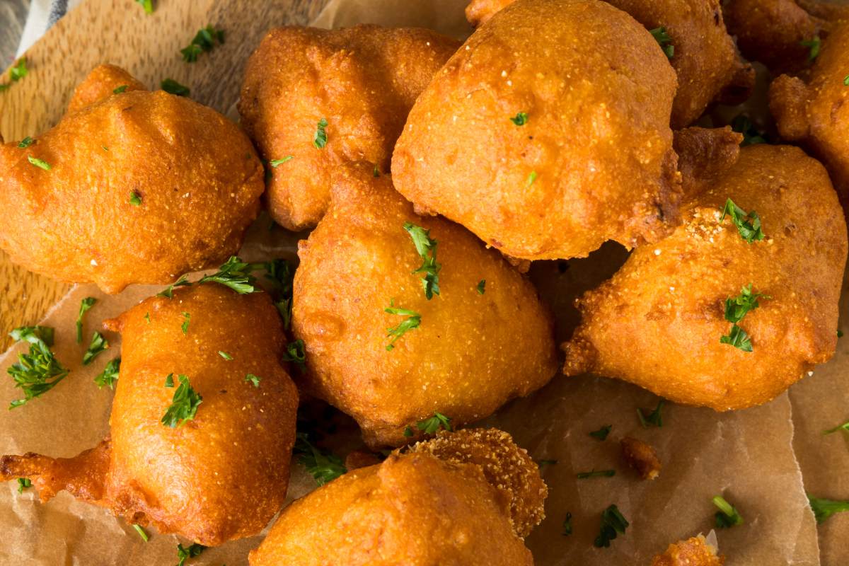 fried hush puppies on paper.