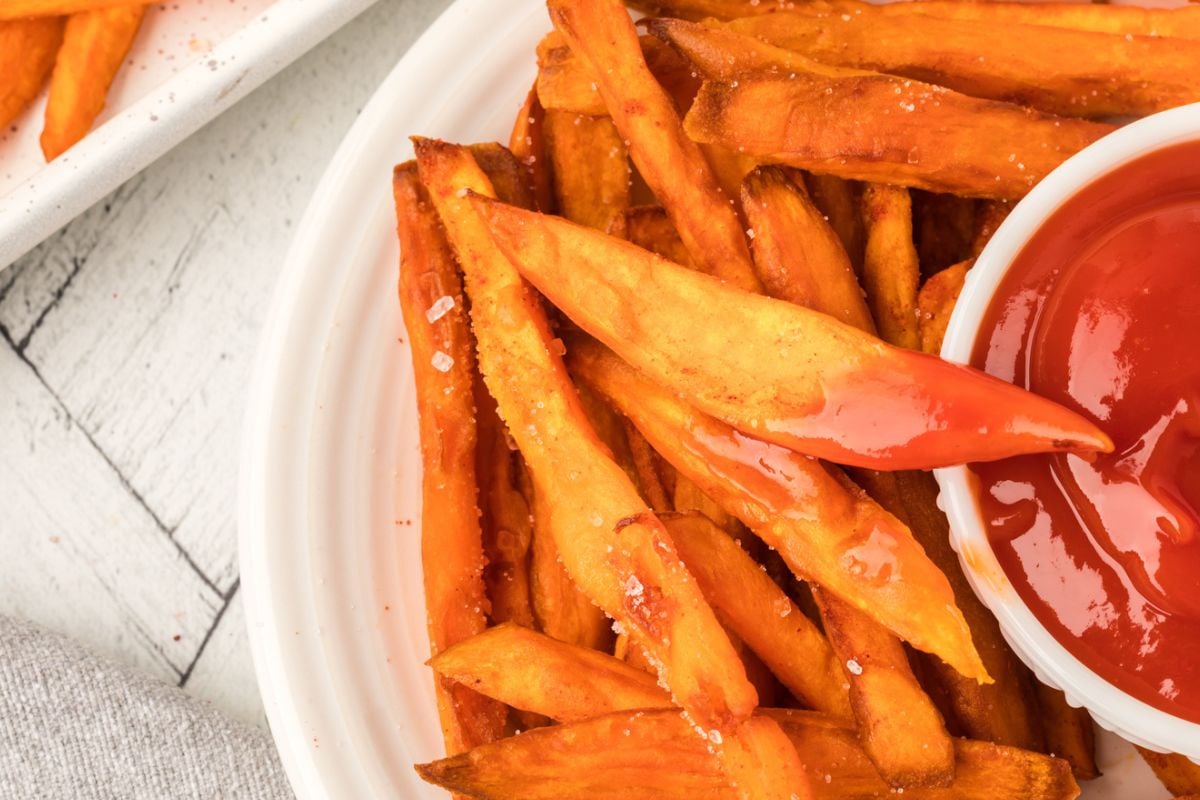 close. up view of deep fried potato fries with ketchup.