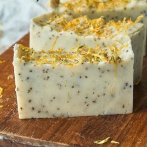 close up view of soap bar with yellow flowers on top.
