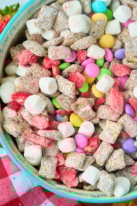 blue bowl with colorful spring chex mix.