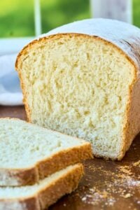 cut loaf of bread on cutting board.