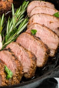 close up of sliced pork tenderloin in skillet.