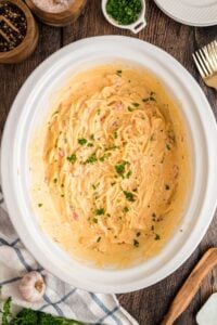 finished chicken spaghetti in white slow cooker.