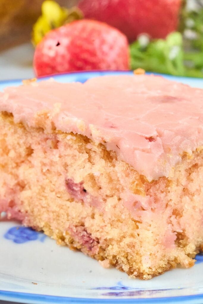 close up view of strawberry cake with pink frosting.